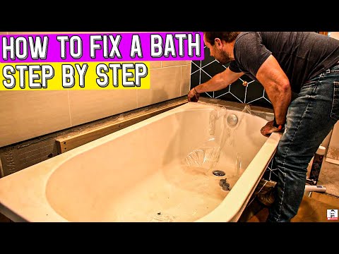 HOW TO FIX A BATH TO A WALL AND SCREW THE FEET DOWN.