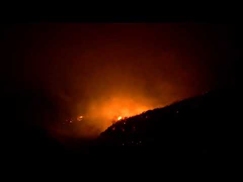 Helicopters battle wildfire in Mentone, California, USA