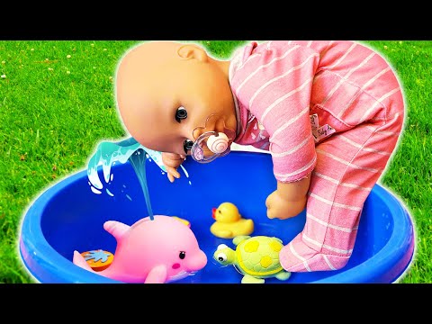 Baby Annabell doll plays with water toys in a colorful container. Baby dolls videos for kids.