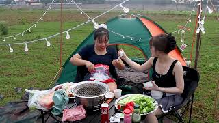 Two girls camp overnight on a wild riverbank - eating BBQ