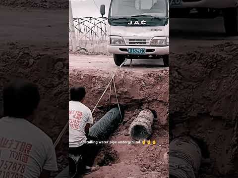 Smart tip installing water pipe underground with truck