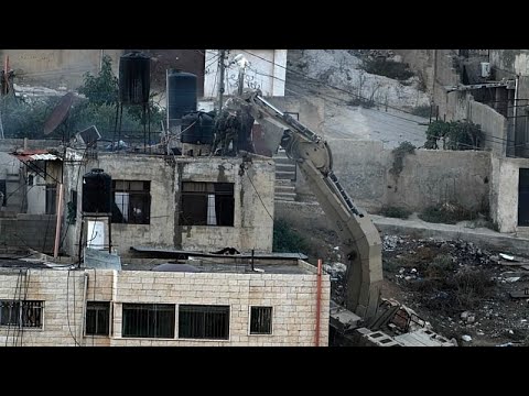 YouTube video thumbnail: Fact Check: Does a Video Show Israeli Soldiers Pushing Bodies From a Rooftop?