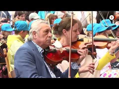 YouTube video thumbnail: Generations Unite to Set New Record for Largest String Orchestra