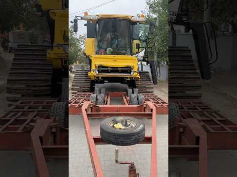 THE HARVESTER WILL CLIMB ON TOP OF THE TRAILER