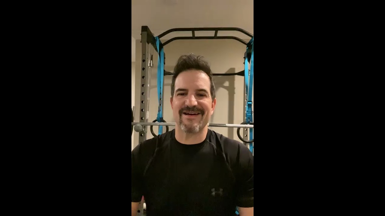 Smiling man in workout space, fitness enthusiast.