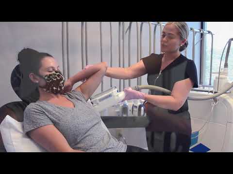 Patient receiving a skincare treatment at clinic.