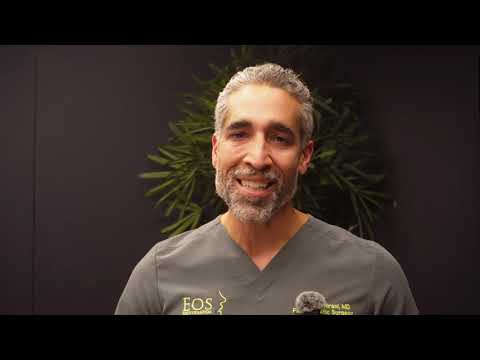 Smiling doctor speaking in professional setting.