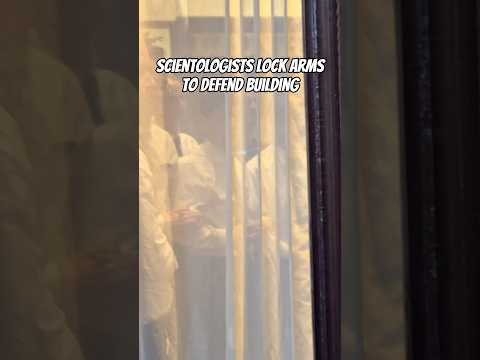 Scientology under siege: Scientologists lock arms to defend building