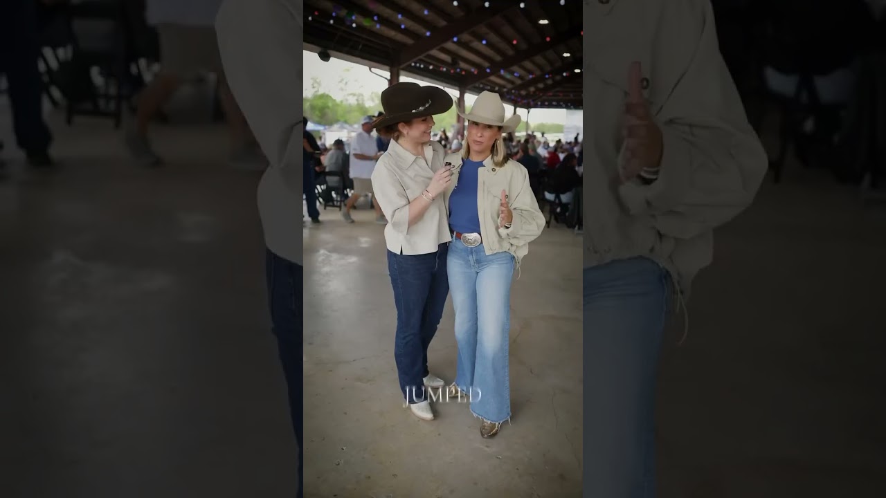 Two women in cowboy hats enjoying an event.