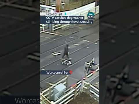 CCTV catches man climbing through level crossing to get over train tracks  #itvnews #uk #news