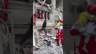 Iranian rescue teams pull father and child from the rubble