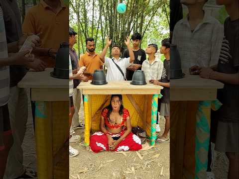 The girl sitting under the table is earning money by swapping ball.