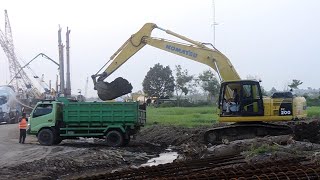 Sany SR 155 Rotary Rig is drilling for bridge pylons. Komatsu PC 200 moves soil to Dump Truck