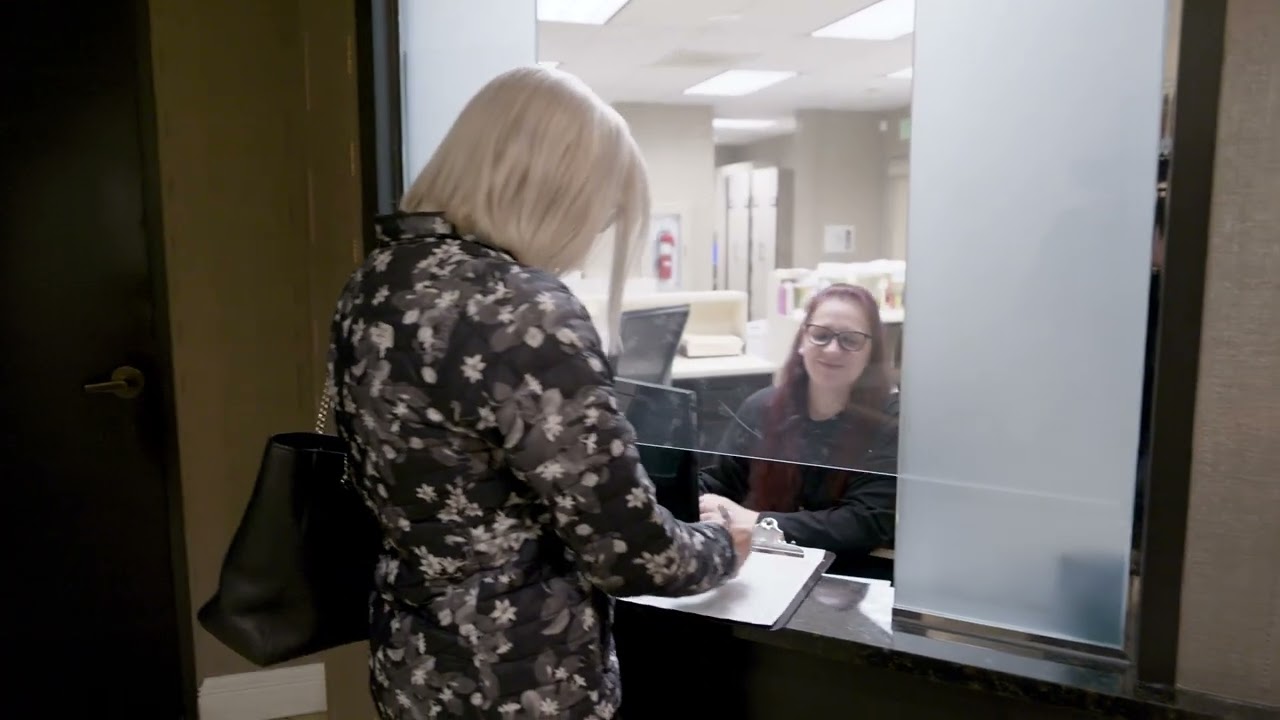 Person checking in at a reception desk.