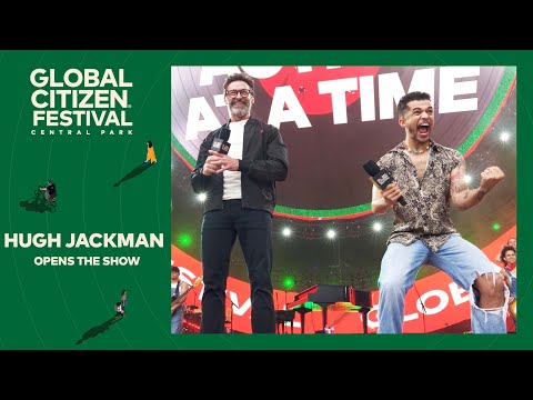 Host Hugh Jackman on stage with presenters | Global Citizen Festival NYC 2024