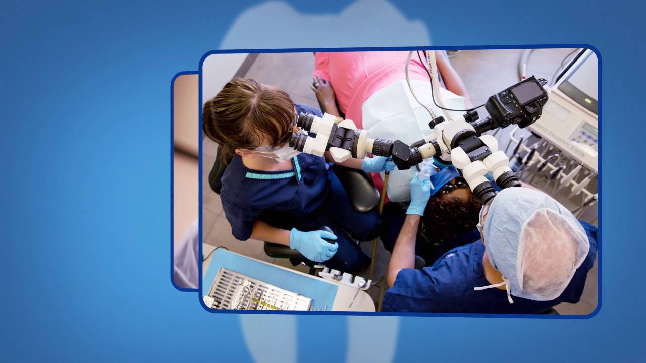 Overhead view of endodontist and assistant performing root canal treatment on patient