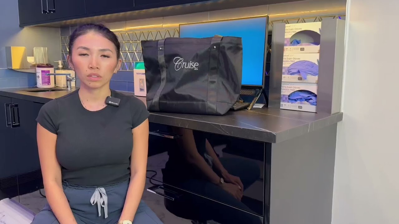 Woman sitting in front of a black tote bag.