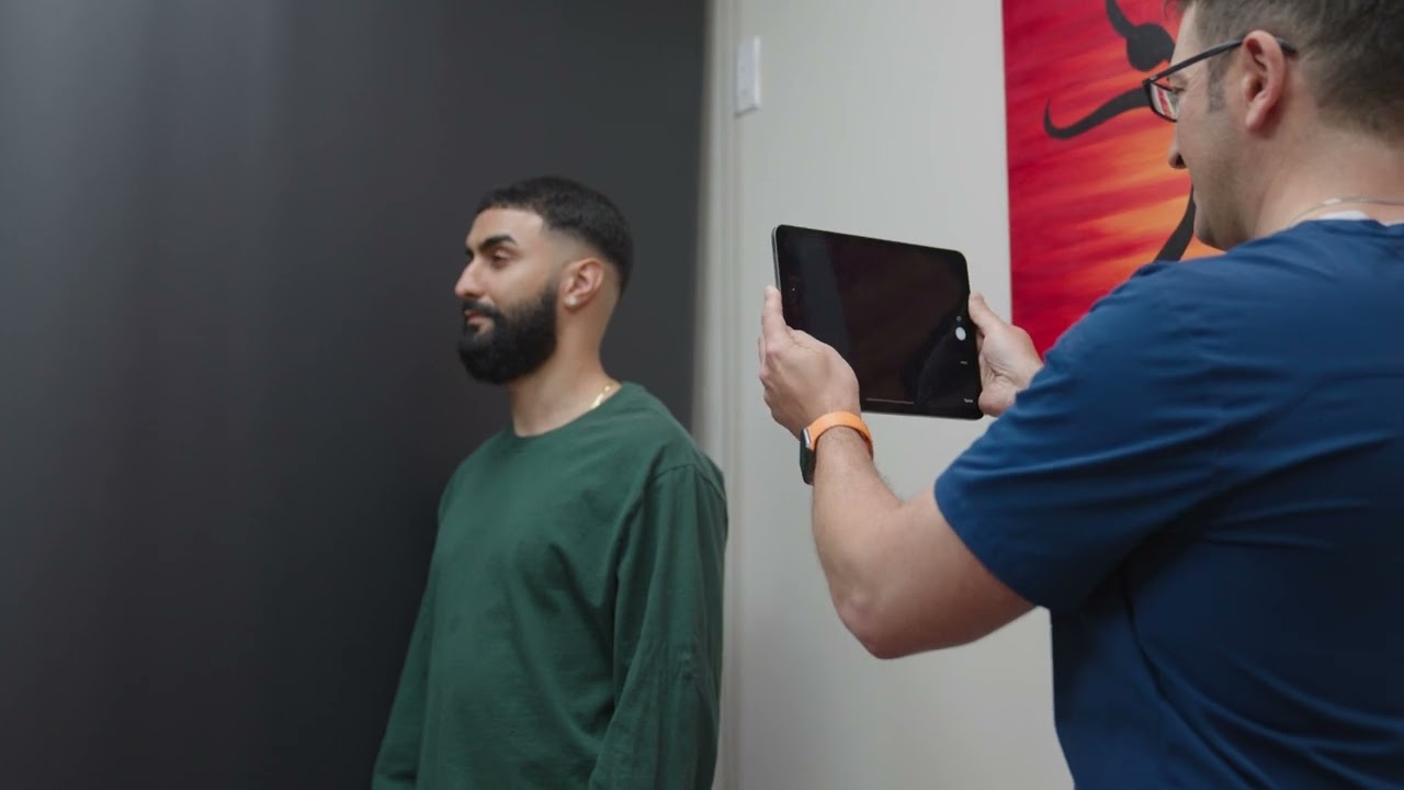 Person being photographed with a tablet device.
