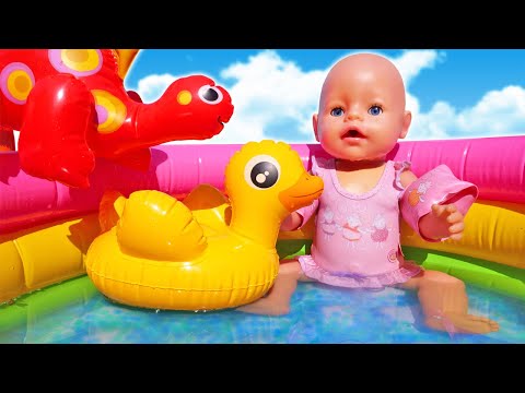 Baby Annabell doll tries swimming in the water pool for kids & eats toy fruits for dolls.