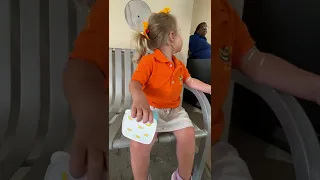 Cute toddler is waiting for car after visiting doctor