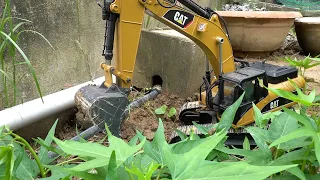 Control a miniature Excavator to dig holes for planting trees.