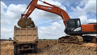 HITACHI ZAXIS 350LCH AND HYUNDAI 12-WHEEL SOIL TRANSPORT TRUCKS