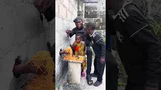 Baby taking spaghetti 