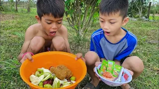 The poor boy& the rich boy are eating chicken tight & fresh fruit in the farm.