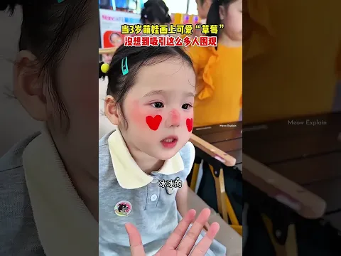 Mother dresses her daughter up like a strawberry