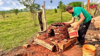 Building brick oven in the middle of the field on a beautiful sunny day 4K