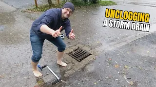 #009  Unclogging a storm drain after rain on a gravel car park in Germany