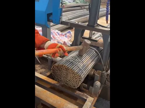 Worker working not hard with cutting large amount of iron rods with old machine