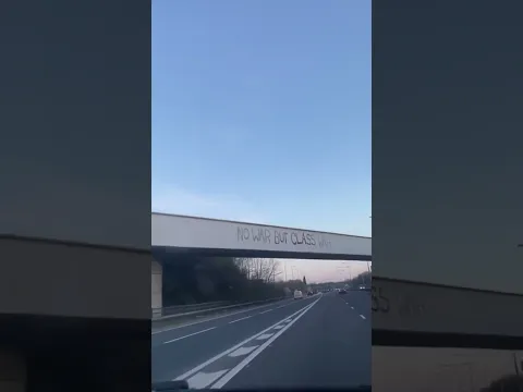 "No War but Class War" seen on the M60 near Manchester, UK