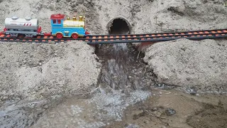 The train travels along a dangerous mountain road across the river and arrives at the station