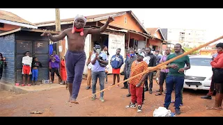MAN WALKS ON A ROPE BETWEEN ELECTRICITY POLE AND A BIG TREE
