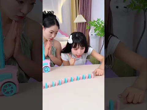 Big Sister Taught Her the Secret to Making the Domino Train Work