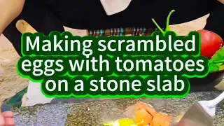 Tomato and egg stir-fry on a stone slab