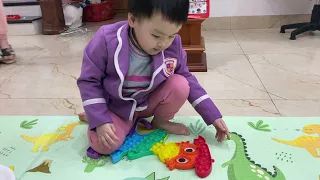 Baby playing pop it in the house