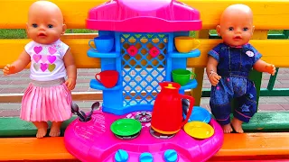Polina make breakfast on the toy kitchen for her baby dolls