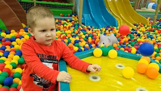 Children's playground: we swim in a pool with colorful balls and slide down the slide