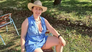BBQ. Grilled sausages. Cooking in a mountain village. Mila cooking on an open fire. Mila naturist.