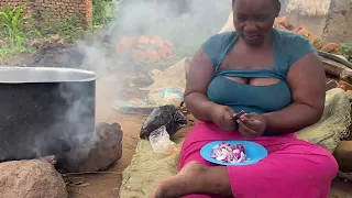 African mother prepares the lunch meal for the kids