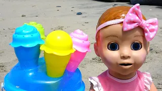 Oceanside. Sand molds, dolls, ocean and fun.